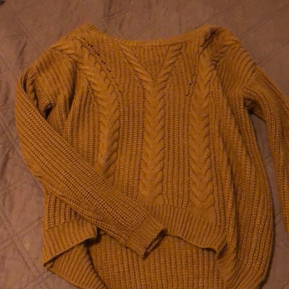 Orange sweater with cross in the back